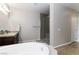 Main bathroom with a soaking tub, shower, and granite countertops at 176 Dunblane St, Henderson, NV 89012