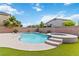 Backyard pool and attached hot tub with lush landscaping and privacy wall, perfect for outdoor relaxation and entertaining at 176 Dunblane St, Henderson, NV 89012