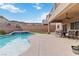 Inviting backyard pool and spa with covered patio and stylish outdoor seating, perfect for enjoying the mountain views at 176 Dunblane St, Henderson, NV 89012