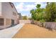 Large backyard with stone ground cover, mature trees, and block wall fencing at 1804 Michael Ct, Henderson, NV 89014