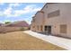 Spacious backyard with stone ground cover, block wall fencing and sliding glass doors at 1804 Michael Ct, Henderson, NV 89014