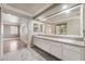 Bathroom featuring double sinks, a large mirror, and access to a bedroom at 1804 Michael Ct, Henderson, NV 89014