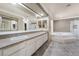Bathroom featuring double sinks, a jacuzzi tub, and a separate glass enclosed shower at 1804 Michael Ct, Henderson, NV 89014