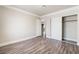 This bedroom has wood-look floors, sliding closet doors and an entry door at 1804 Michael Ct, Henderson, NV 89014