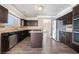 Dark wood cabinets, stainless appliances and a central island make this kitchen a chef's delight at 1804 Michael Ct, Henderson, NV 89014