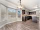Eat-in kitchen features dark wood cabinets, modern appliances and sunny bay windows at 1804 Michael Ct, Henderson, NV 89014