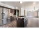 An eat-in kitchen with stainless steel appliances, dark cabinets, and wood floors at 1804 Michael Ct, Henderson, NV 89014