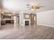 Open-concept living room featuring a fireplace, ceiling fan, and wood-style flooring throughout at 1804 Michael Ct, Henderson, NV 89014