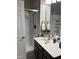 Bathroom features a walk-in shower and a vanity with a black cabinet at 1830 N Buffalo Dr # 2021, Las Vegas, NV 89128