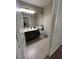 Well-lit bathroom with gray vanity, tile flooring, and a large mirror at 1830 N Buffalo Dr # 2021, Las Vegas, NV 89128