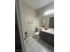 Bathroom with a toilet, vanity, mirror, tiled floors, and neutral wall color at 1830 N Buffalo Dr # 2021, Las Vegas, NV 89128