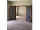 Bedroom showcasing an open closet with gray curtains, providing storage and style at 1830 N Buffalo Dr # 2021, Las Vegas, NV 89128