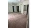 Large bedroom with mirrored closet doors, neutral paint, and plush carpeting at 1830 N Buffalo Dr # 2021, Las Vegas, NV 89128