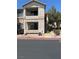 Exterior view of a two-story condo with private balconies and exterior stairs at 1830 N Buffalo Dr # 2021, Las Vegas, NV 89128