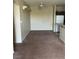Open-concept living room with neutral walls, plush carpeting, and lots of natural light at 1830 N Buffalo Dr # 2021, Las Vegas, NV 89128