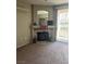 Spacious living room with a decorative fireplace and natural light streaming through the sliding glass door at 1830 N Buffalo Dr # 2021, Las Vegas, NV 89128