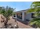 Relaxing covered back patio with dining set and desert landscaping at 2188 Cumberland Hill Dr, Henderson, NV 89052