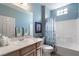 Fresh bathroom with tub and shower combo, light vanity, and blue accents at 2188 Cumberland Hill Dr, Henderson, NV 89052