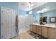 Bright bathroom featuring a double vanity, a glass-enclosed shower, and modern fixtures at 2188 Cumberland Hill Dr, Henderson, NV 89052