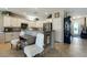 Eat-in kitchen with breakfast bar, stainless steel appliances, and white cabinetry at 2188 Cumberland Hill Dr, Henderson, NV 89052