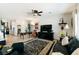 Spacious living room featuring tile flooring, a ceiling fan, and ample natural light at 2188 Cumberland Hill Dr, Henderson, NV 89052