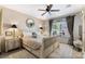Serene bedroom with a ceiling fan, neutral décor, and a large window at 2188 Cumberland Hill Dr, Henderson, NV 89052