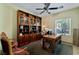 Cozy home office with built-in bookshelves, a large desk, and natural light at 2188 Cumberland Hill Dr, Henderson, NV 89052