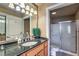 Well-lit bathroom featuring granite counters, a sink, and a shower with sliding glass doors at 220 E Flamingo Rd # 317, Las Vegas, NV 89169