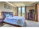 Cozy bedroom with plush carpeting, a queen-sized bed, and a large window with natural light at 220 E Flamingo Rd # 317, Las Vegas, NV 89169