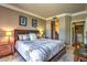 Comfortable bedroom with a queen bed, ambient lighting, and convenient access to the bathroom and laundry at 220 E Flamingo Rd # 317, Las Vegas, NV 89169