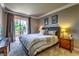 Elegant bedroom featuring a queen bed, a private balcony, and stylish decor at 220 E Flamingo Rd # 317, Las Vegas, NV 89169