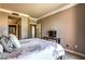 Comfortable bedroom featuring neutral tones, carpet, and a tv sitting on a wooden shelf at 220 E Flamingo Rd # 317, Las Vegas, NV 89169