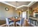 Dining area with seating for four, neutral colors, and access to kitchen and entry at 220 E Flamingo Rd # 317, Las Vegas, NV 89169