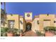 Exterior shot of a clubhouse with a tile roof, desert landscaping and an archway at 220 E Flamingo Rd # 317, Las Vegas, NV 89169