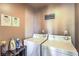 Functional laundry room featuring a washer, dryer, and laundry-related wall decor at 220 E Flamingo Rd # 317, Las Vegas, NV 89169