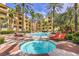 Community pools surrounded by palm trees and lush landscaping provide a resort-like experience at 220 E Flamingo Rd # 317, Las Vegas, NV 89169