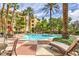 Inviting pool area with lounge chairs, tables, and umbrellas for relaxation and enjoyment at 220 E Flamingo Rd # 317, Las Vegas, NV 89169