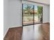 Bedroom features hardwood floors and sliding glass doors to the outdoor space at 2558 La Fortuna Ave, Las Vegas, NV 89121