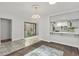 Charming dining area featuring stylish tile flooring, a modern chandelier, and an open layout to the kitchen at 2558 La Fortuna Ave, Las Vegas, NV 89121