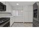 Bright kitchen featuring white cabinetry, stainless steel appliances, and ample counter space at 2558 La Fortuna Ave, Las Vegas, NV 89121