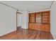 Living room features hardwood floors and a built in wooden bookshelf for storage at 2558 La Fortuna Ave, Las Vegas, NV 89121