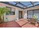 Relaxing covered patio with tile flooring, a dining table, and access to the home's interior at 2558 La Fortuna Ave, Las Vegas, NV 89121