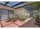 Charming covered patio featuring red tile flooring and an outdoor dining set at 2558 La Fortuna Ave, Las Vegas, NV 89121