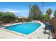 Community pool surrounded by lush landscaping and palm trees offers a relaxing retreat at 2558 La Fortuna Ave, Las Vegas, NV 89121