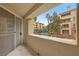 Balcony view showing palm trees and neighboring buildings in a quiet community at 270 E Flamingo Rd # 106, Las Vegas, NV 89169