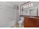 Well-lit bathroom featuring a shower-tub combo with a modern vanity and large mirror at 270 E Flamingo Rd # 106, Las Vegas, NV 89169