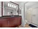 Bathroom featuring a large mirror and updated vanity plus a glass-enclosed shower at 270 E Flamingo Rd # 106, Las Vegas, NV 89169