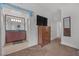 Bedroom with a dresser, TV, and access to the bathroom, creating a suite-like feel at 270 E Flamingo Rd # 106, Las Vegas, NV 89169