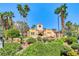 Exterior view of the building featuring lush landscaping and a tiled roof at 270 E Flamingo Rd # 106, Las Vegas, NV 89169