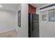 Well-lit hallway area includes a refrigerator and stacked washer/dryer laundry appliances at 270 E Flamingo Rd # 106, Las Vegas, NV 89169
